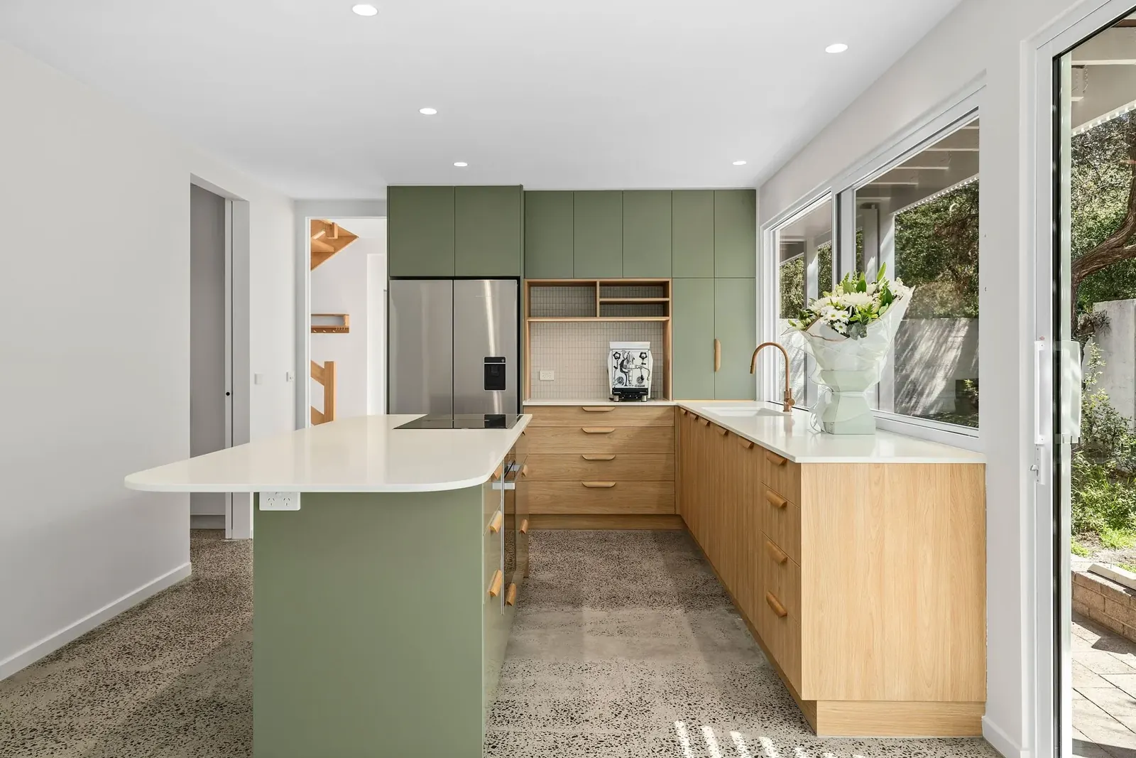 Sage-green kitchen with timber drawers, terrazzo floor and garden windows, Hotham Street Beaumaris — Eco Building Design