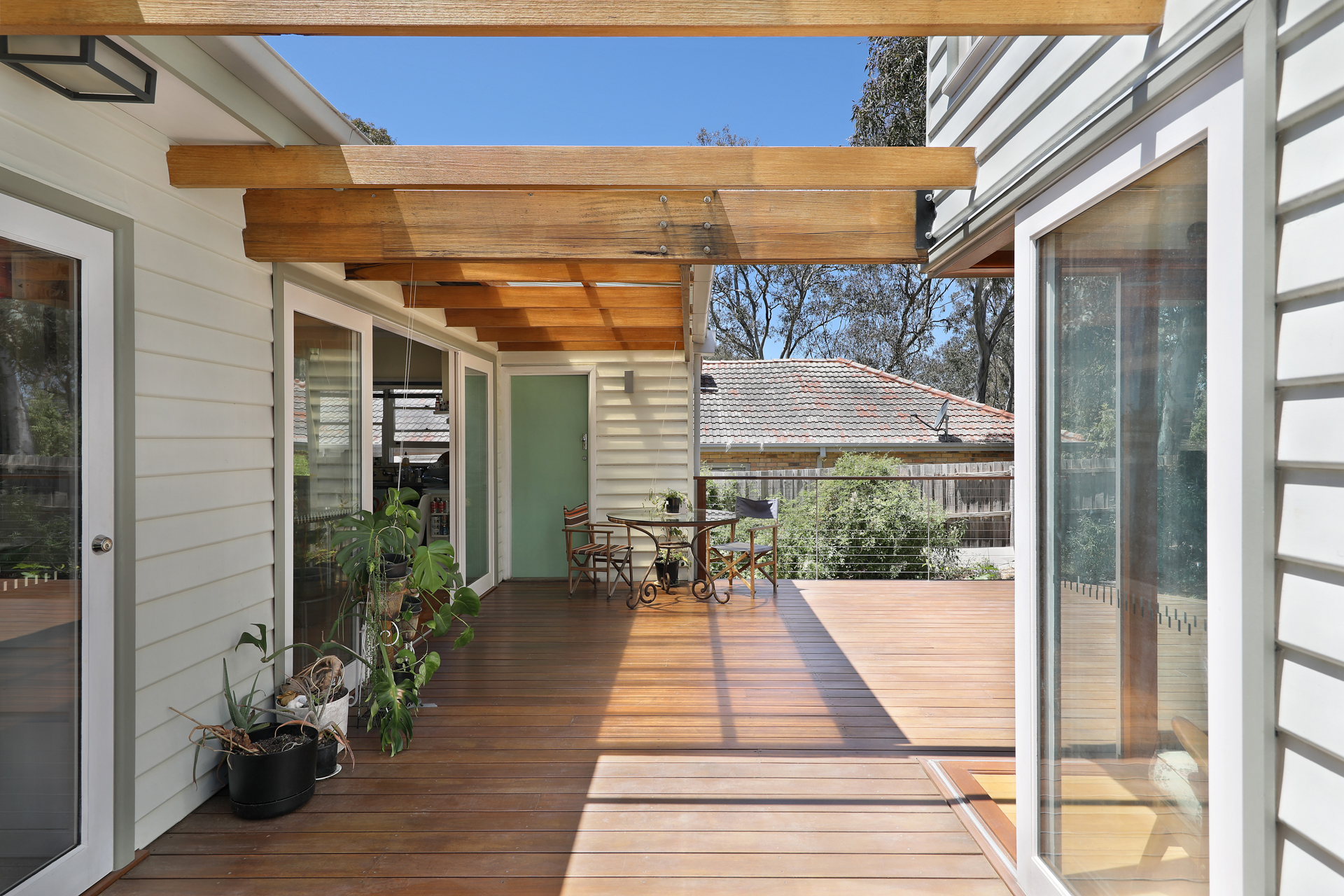 Sun-drenched covered timber deck framed by warm pergola beams, Joynt Street Macleod