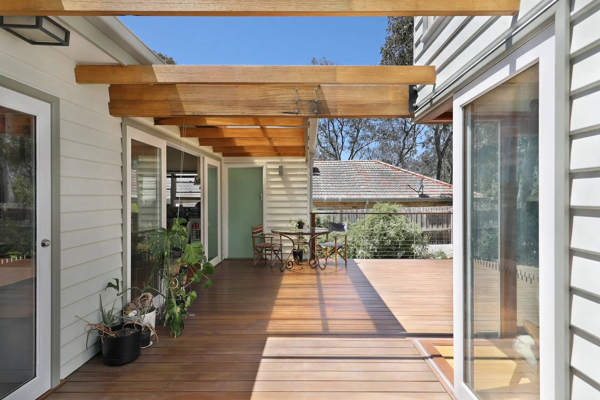 Sun-drenched covered timber deck framed by warm pergola beams, Joynt Street Macleod