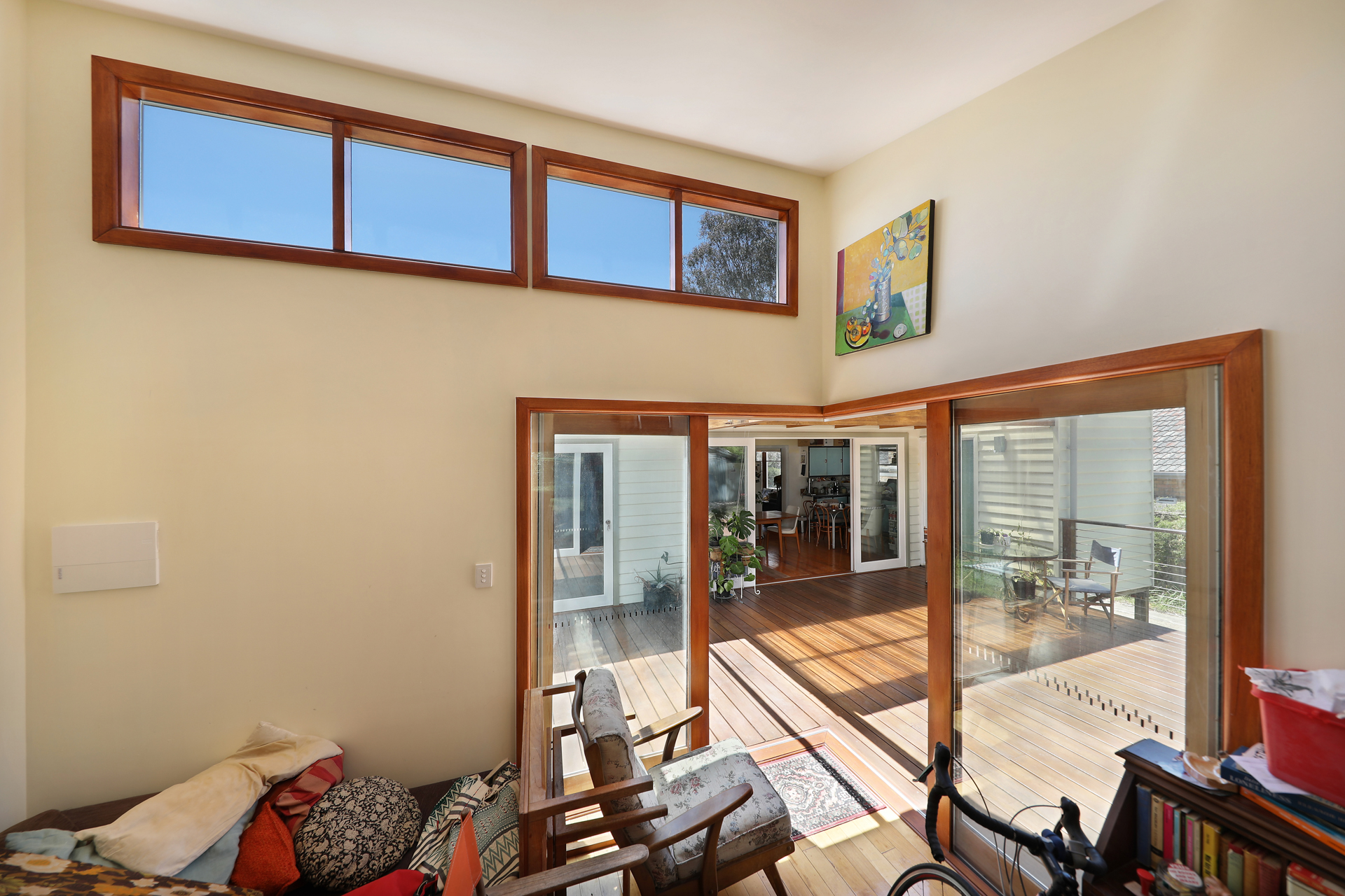 Light-filled interior with timber-framed clerestory windows looking onto the deck, Joynt Street Macleod