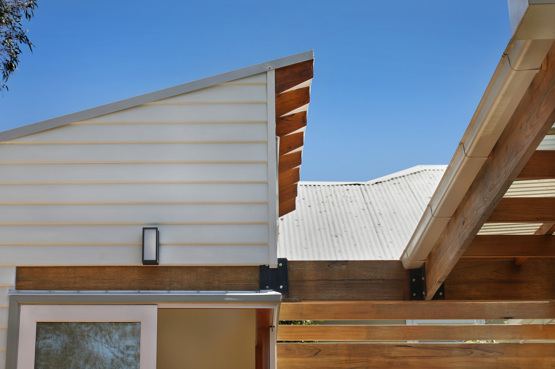 Detail of the skillion roofline with exposed timber rafters and steel bracket, Joynt Street Macleod